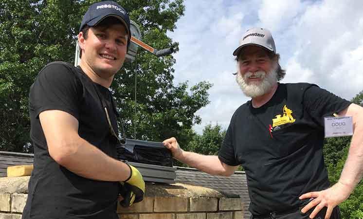 Founder Doug (right) and an Abbey Road Chimney Sweep technician on a rooftop chimney