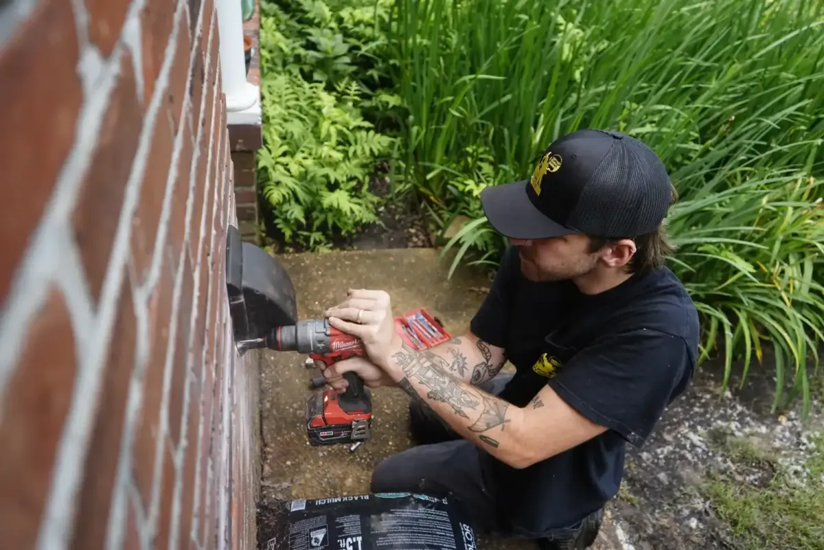 Technician installing a pest-proof dryer-vent cap in Memphis