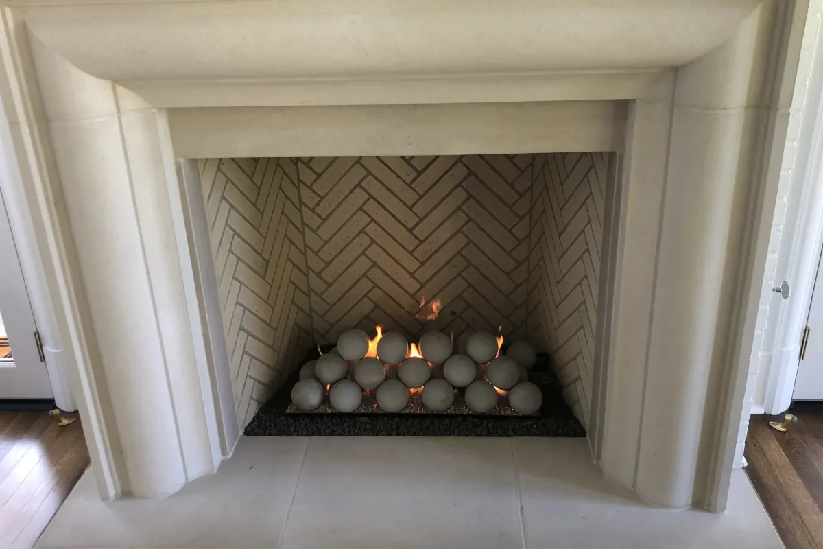 Newly installed gas fireplace with glowing log set